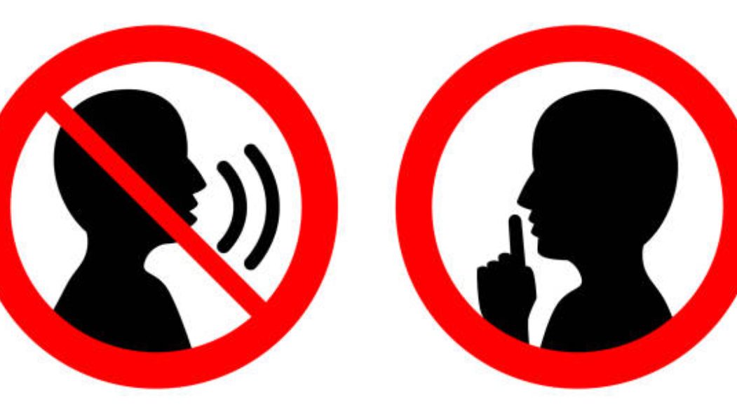 Keep quiet / silent please sign. Crossed person talking / Shhh icon in circle.